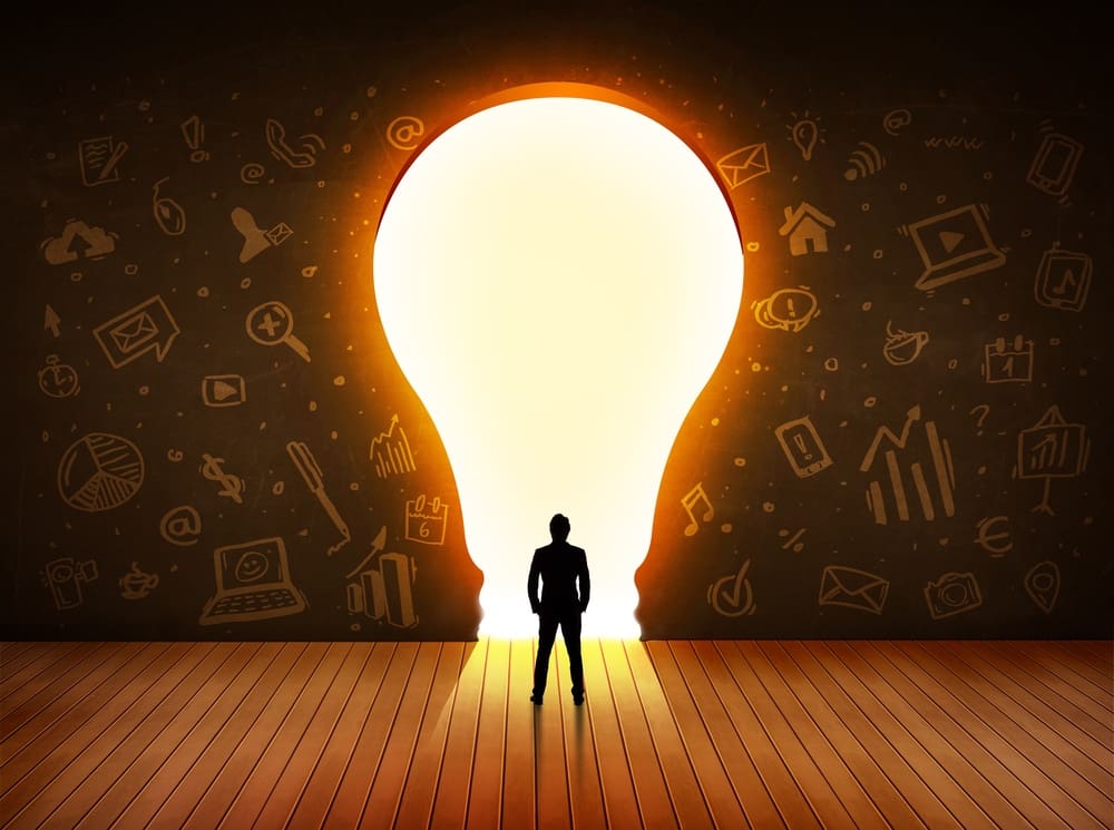 Business man looking at bright light bulb in the wall concept.jpeg