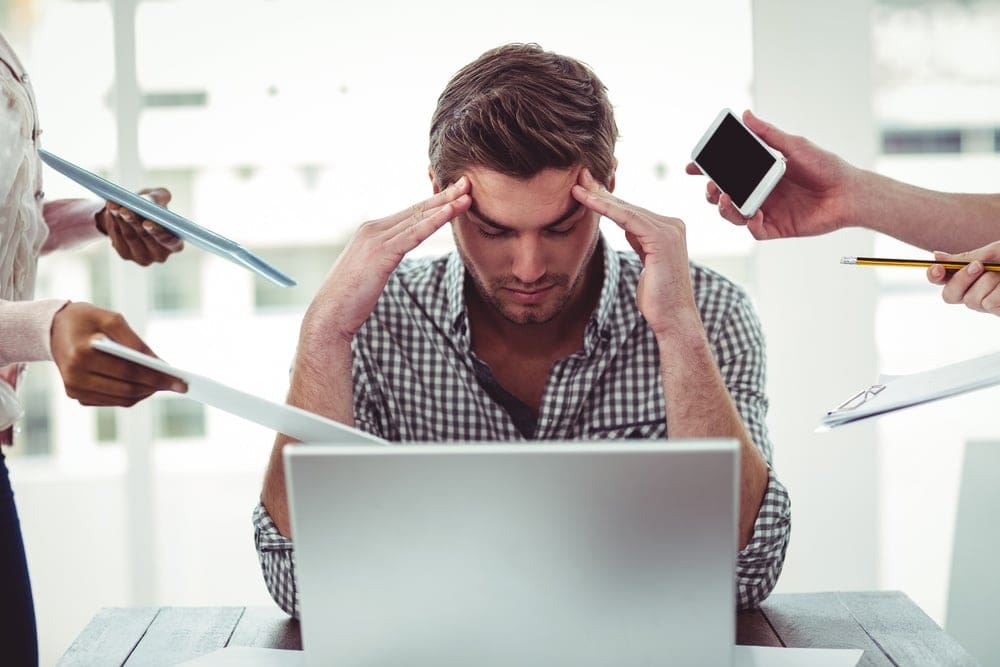Businessman stressed out at work in casual office.jpeg