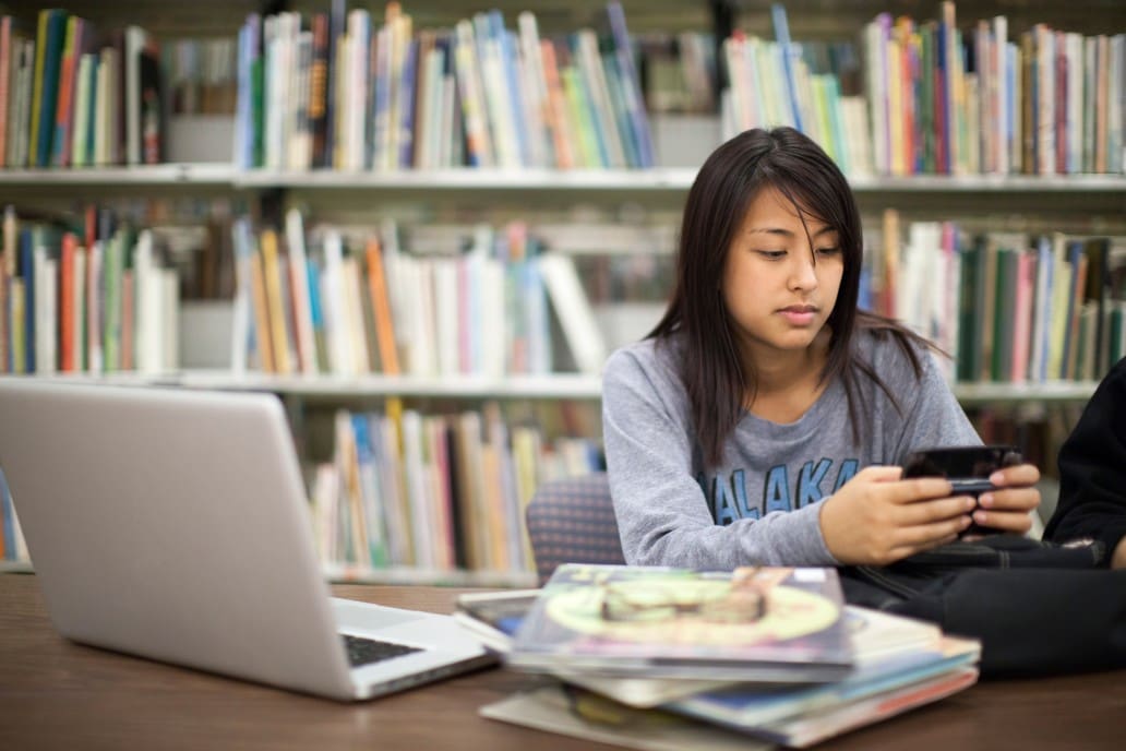 a-young-asian-american-woman-studying-for-finals-in-the-library_t20_a7aEY6